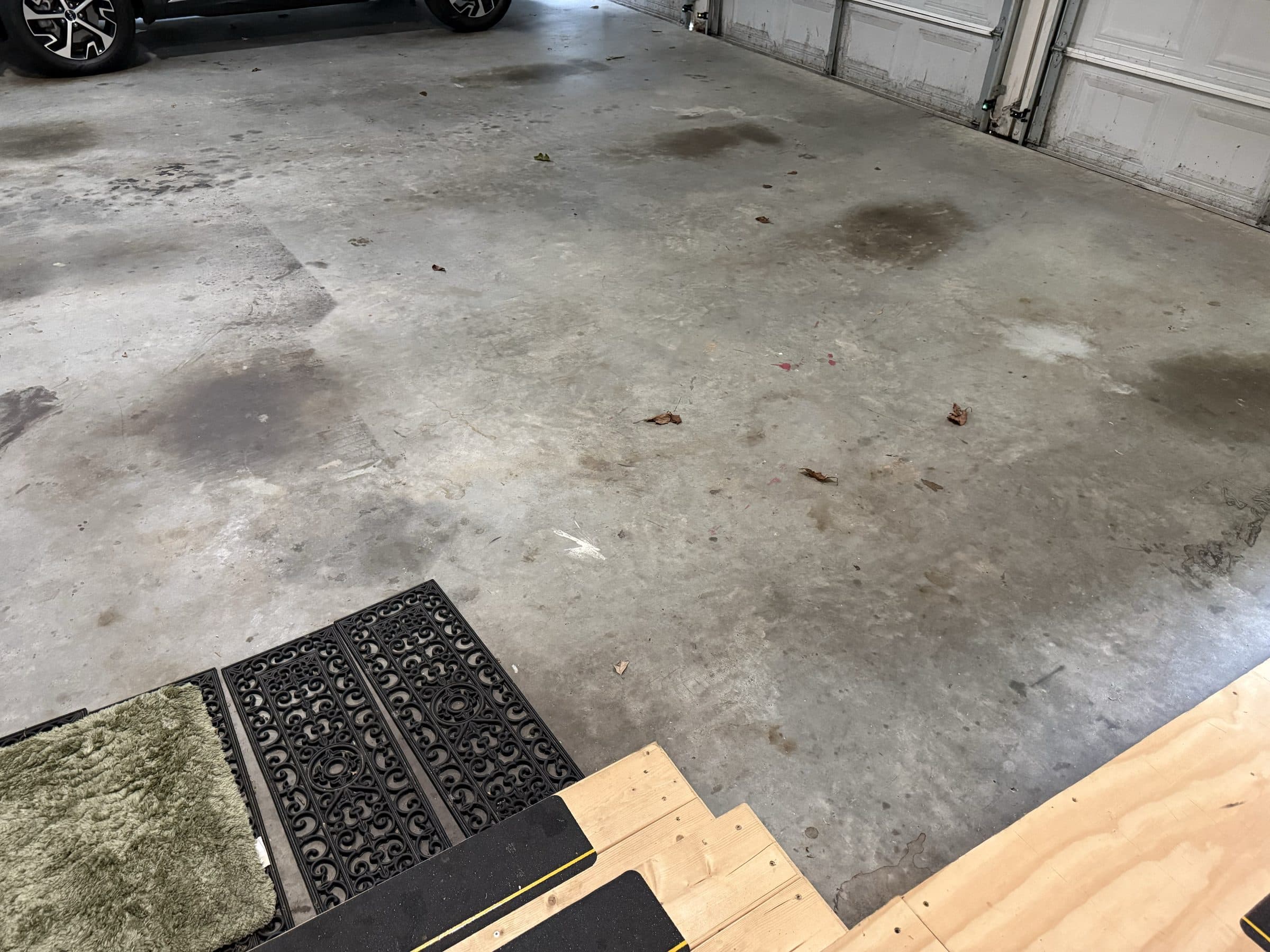 Concrete garage floor with oil stains before epoxy coating