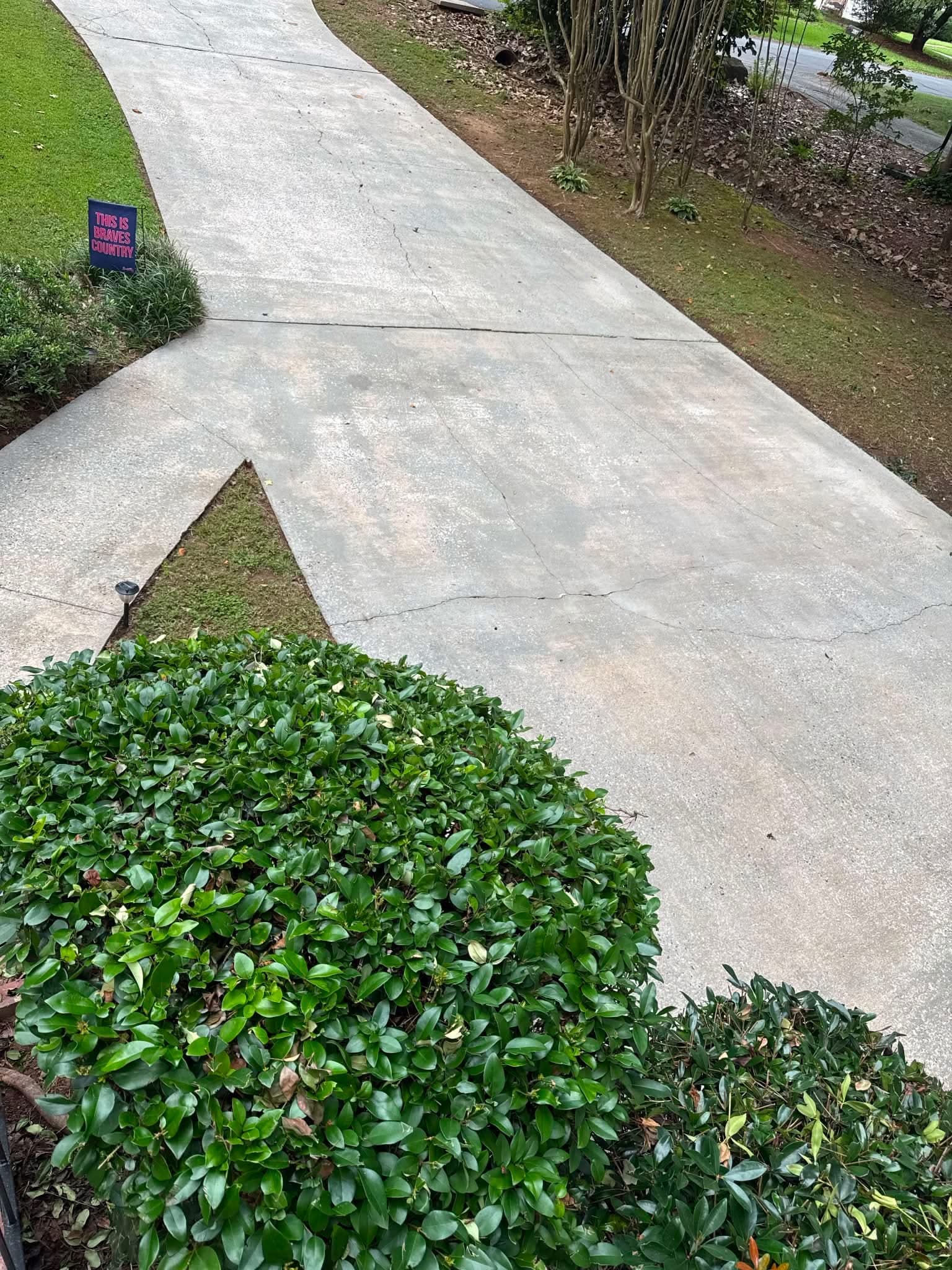 Clean concrete driveway after professional pressure washing