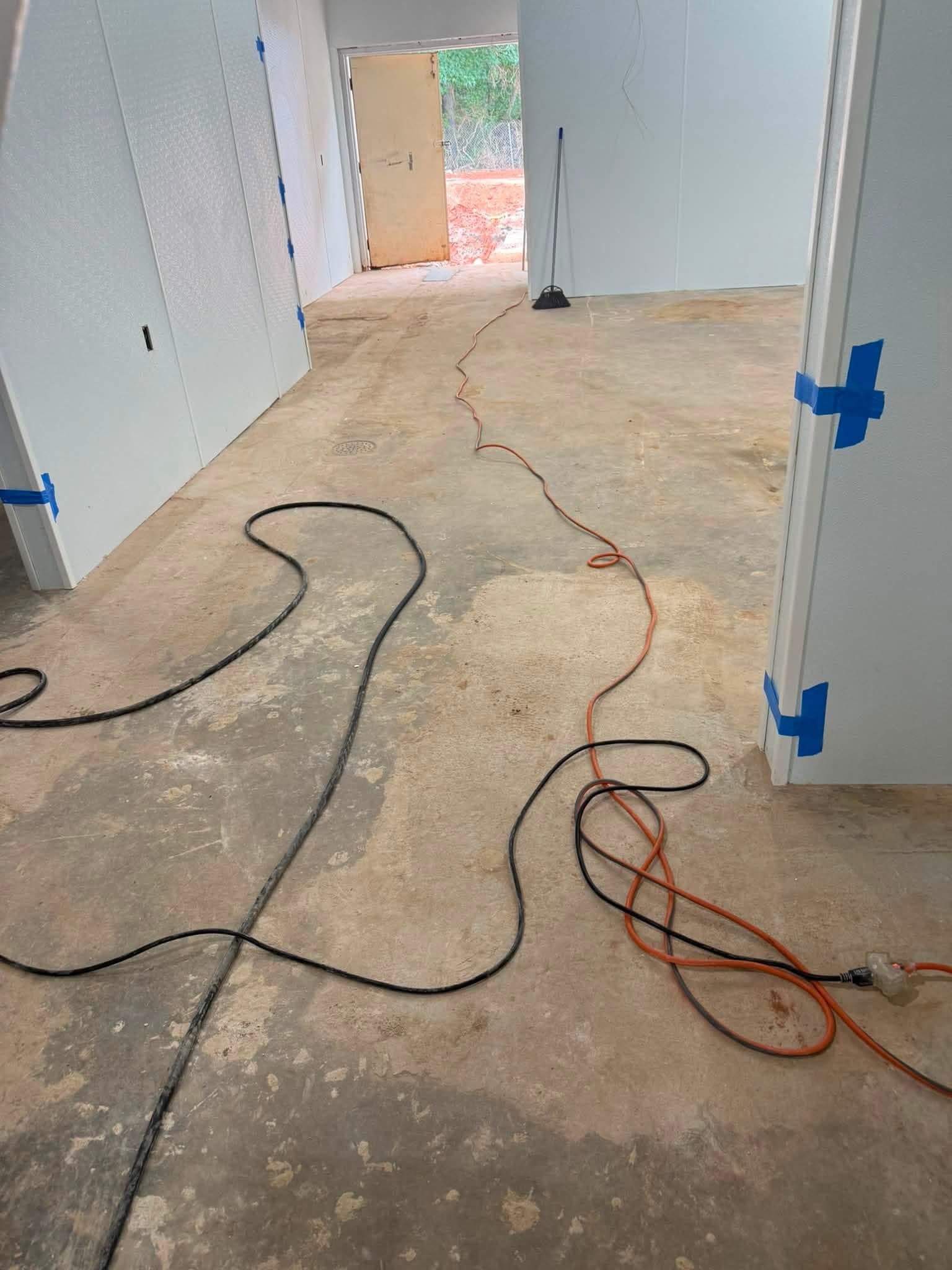 Bare prepped concrete floor before urethane coating in a commercial kitchen build-out