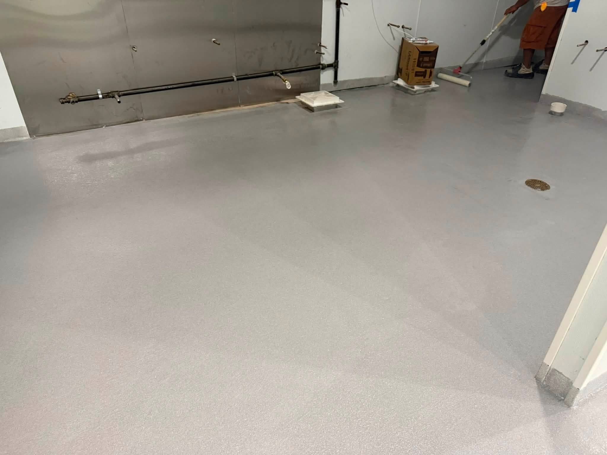 Homegrown Epoxy crew member applying floor coating on a job site