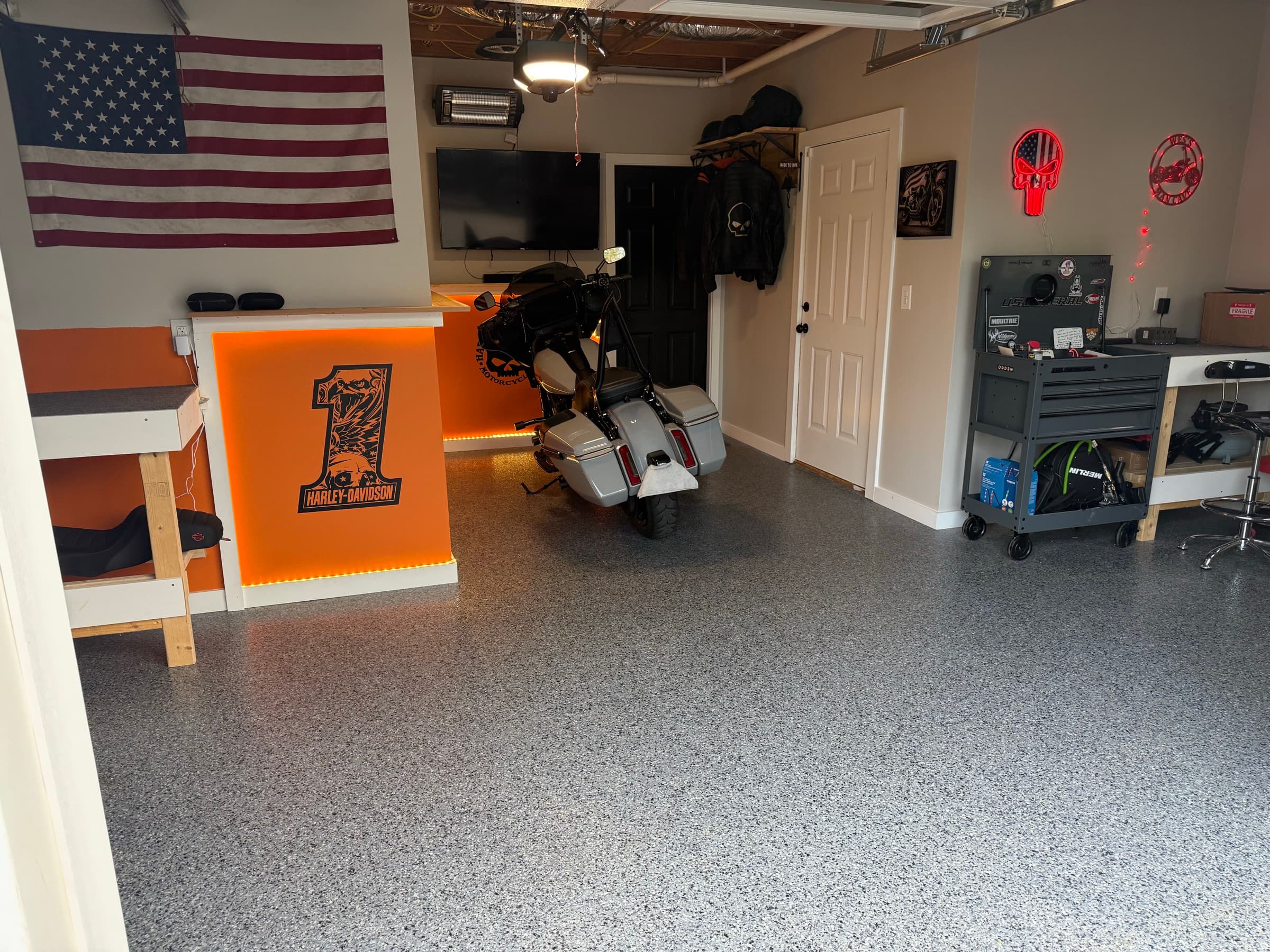 Finished flake epoxy garage floor styled as a motorcycle man-cave